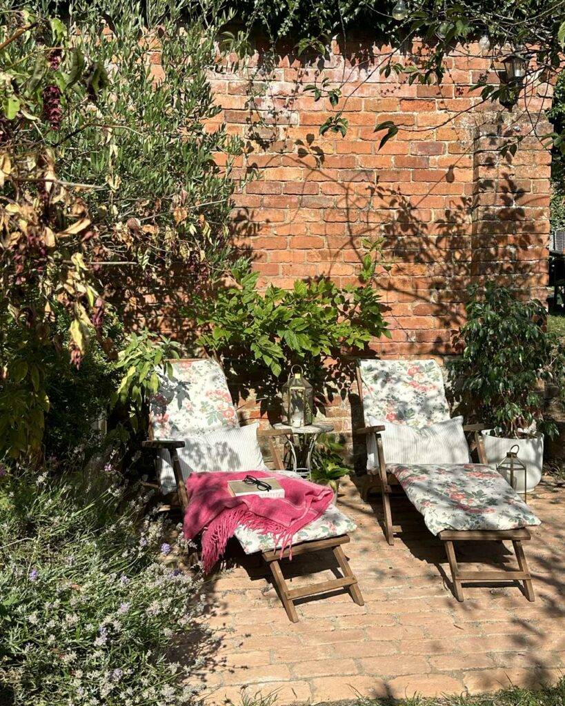 brick pavers with decking chairs and red brick wall